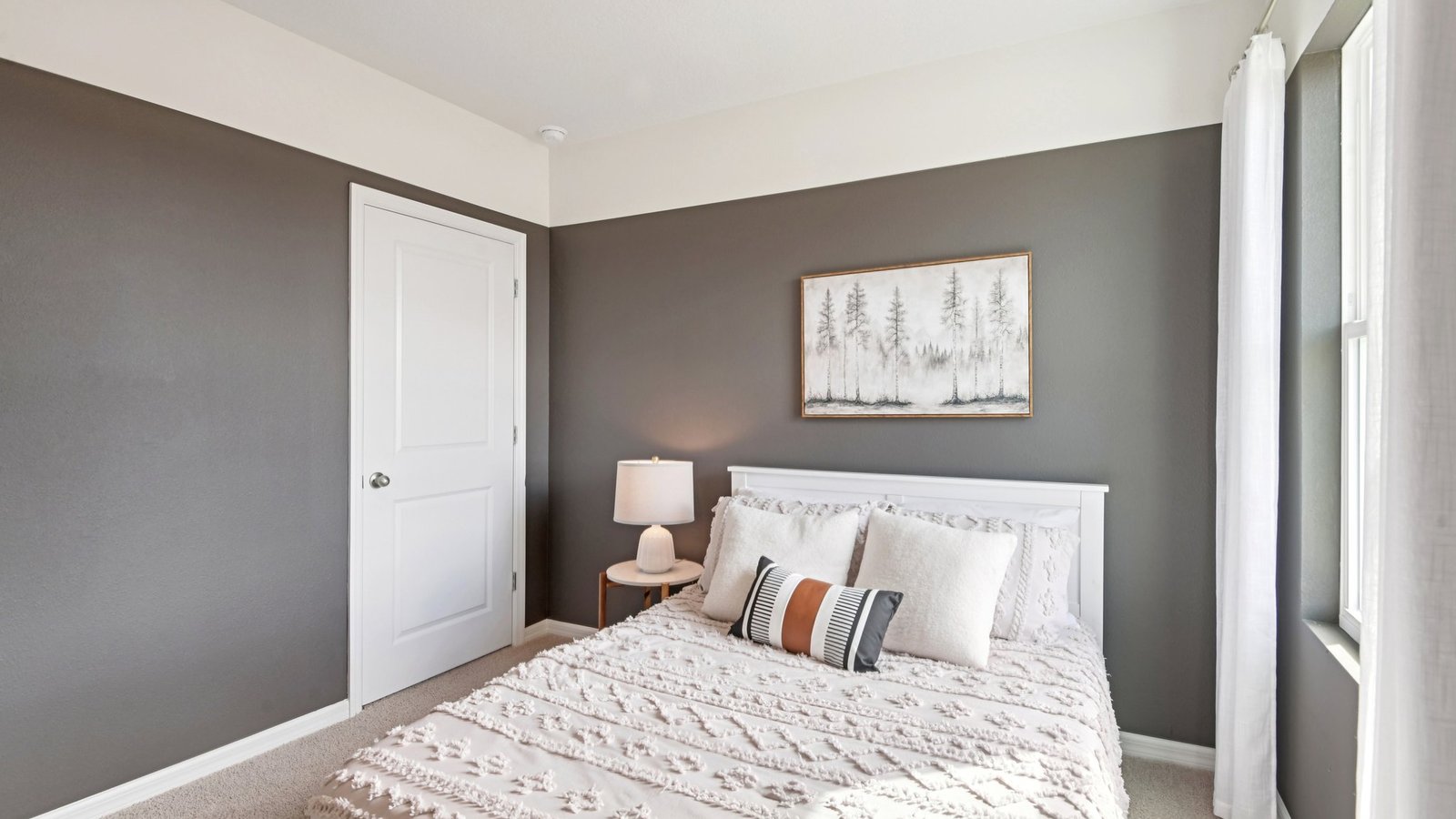 Guest bedroom with bed, nightstands and a roomy closet for storage.