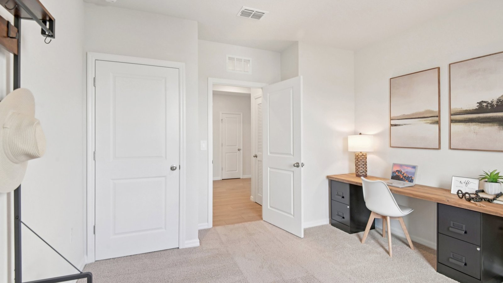 Multi-purpose office space with desk, seating and windows for natural lighting.