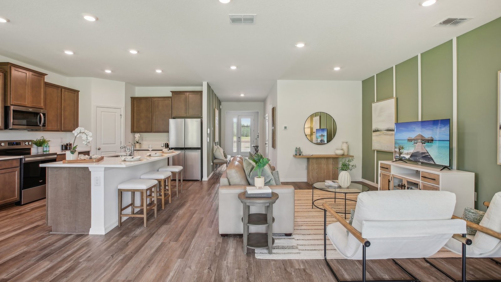 Open concept living area with couch seating and access to the backyard thru slider door.