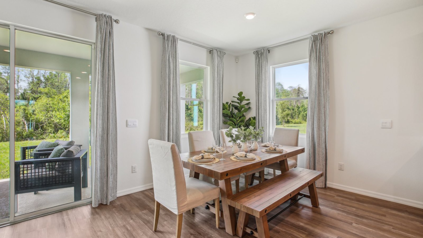 Dining room adjacent to the kitchen with table, chairs and tile flooring.