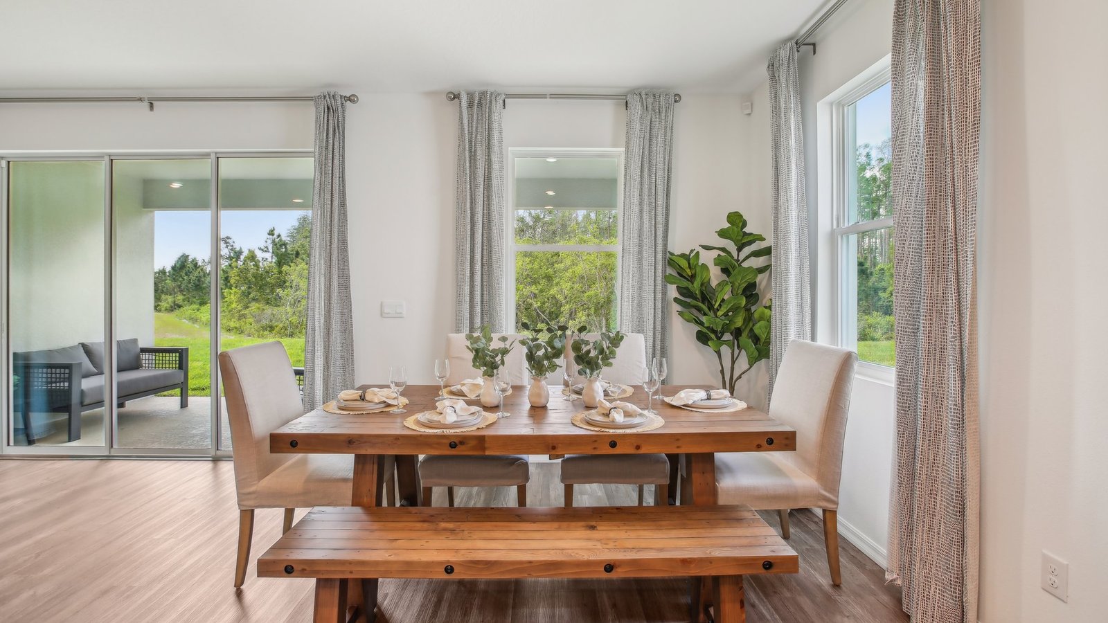 Dining room adjacent to the kitchen with table, chairs and tile flooring.