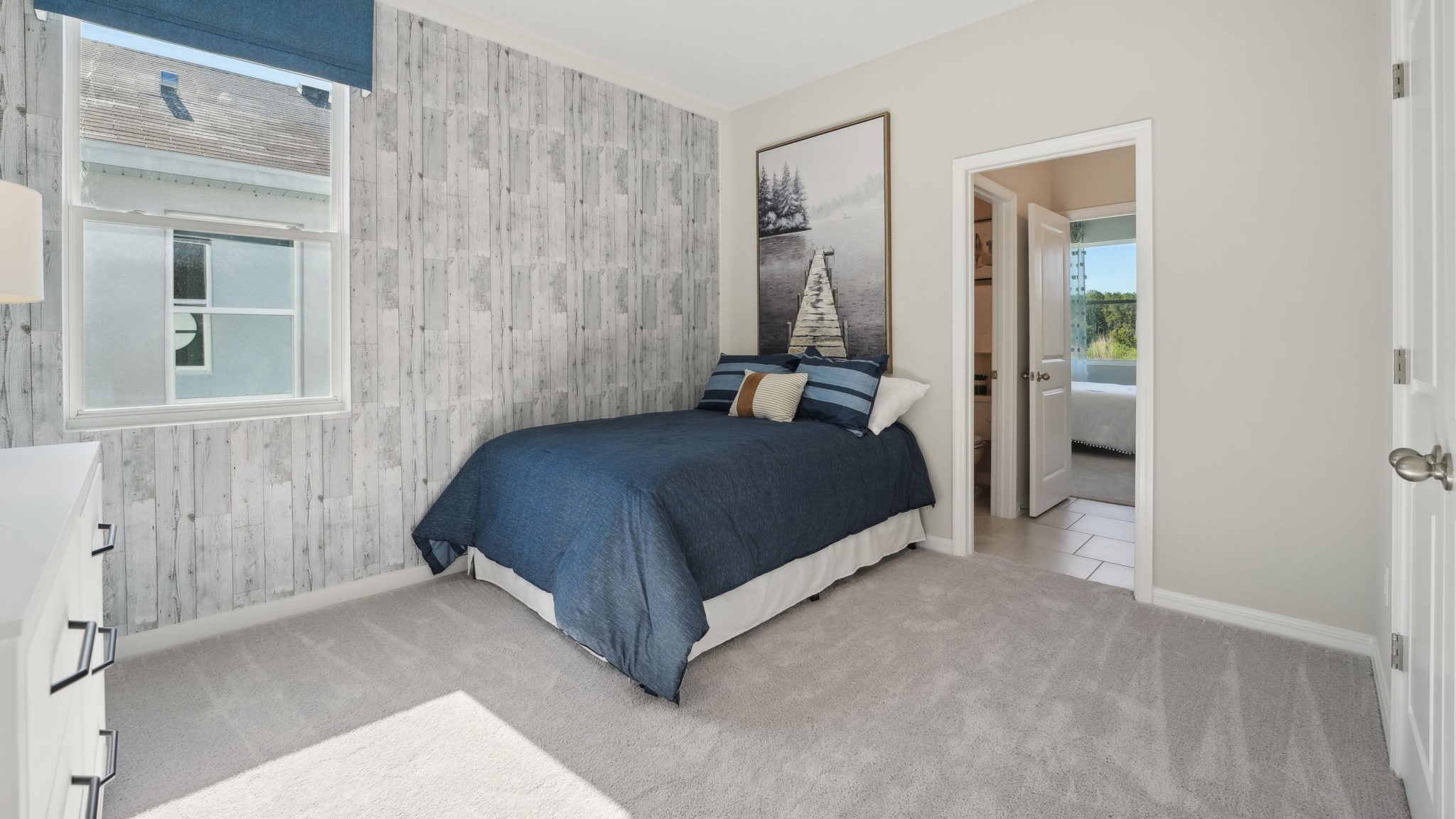 Guest bedroom with bed, nightstands, and a roomy closet for storage.