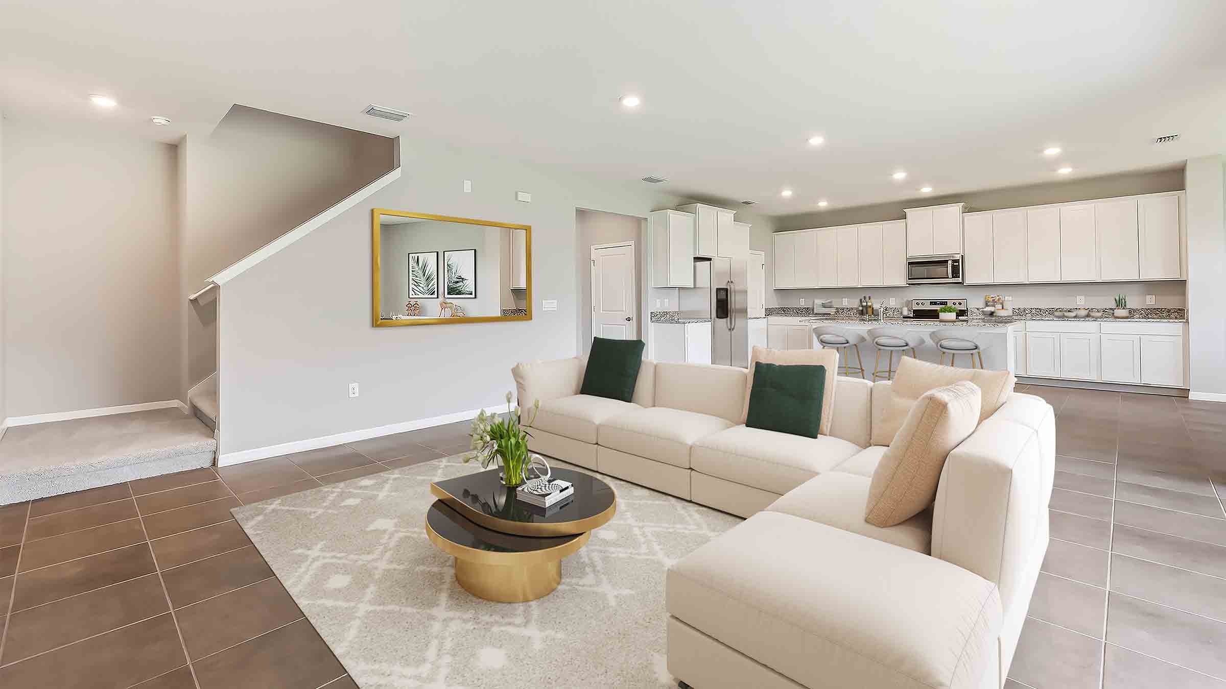 Open concept living area with couch seating and access to the backyard thru slider door.
