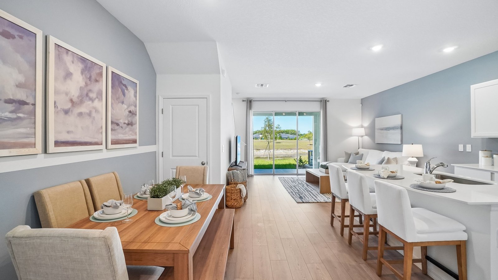 Dining room adjacent to the kitchen with table, chairs and LVP flooring.