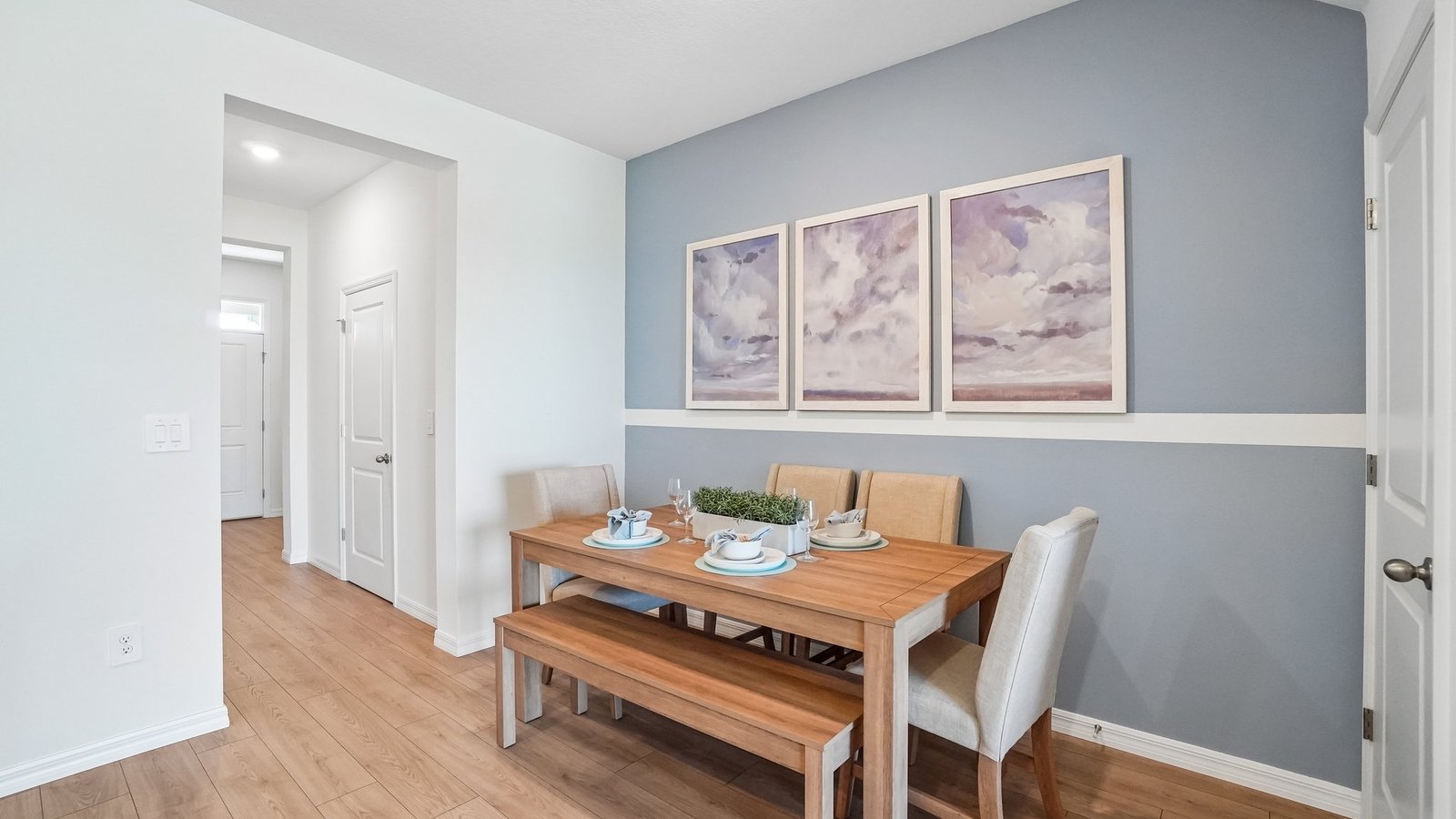 Dining room adjacent to the kitchen with table, chairs and LVP flooring.
