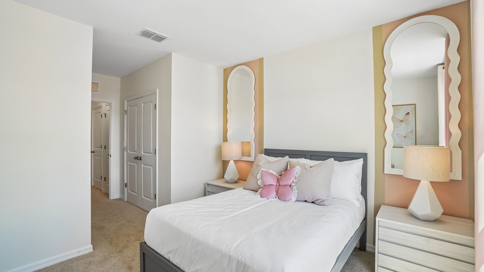 Guest bedroom with bed, nightstands and a roomy closet for storage.