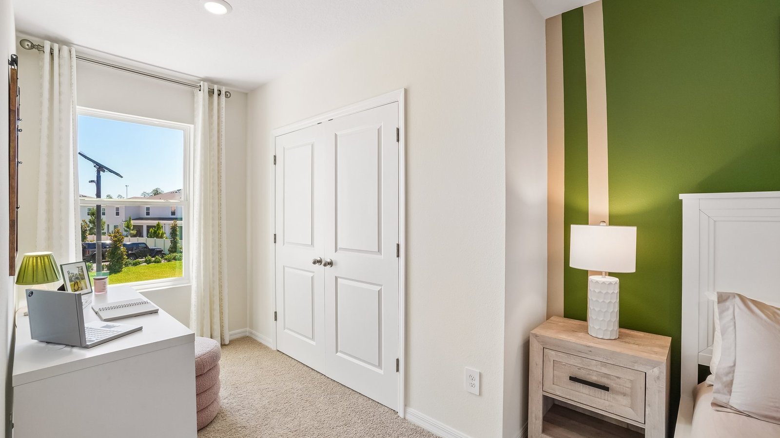 Guest bedroom with bed, nightstands and a roomy closet for storage.