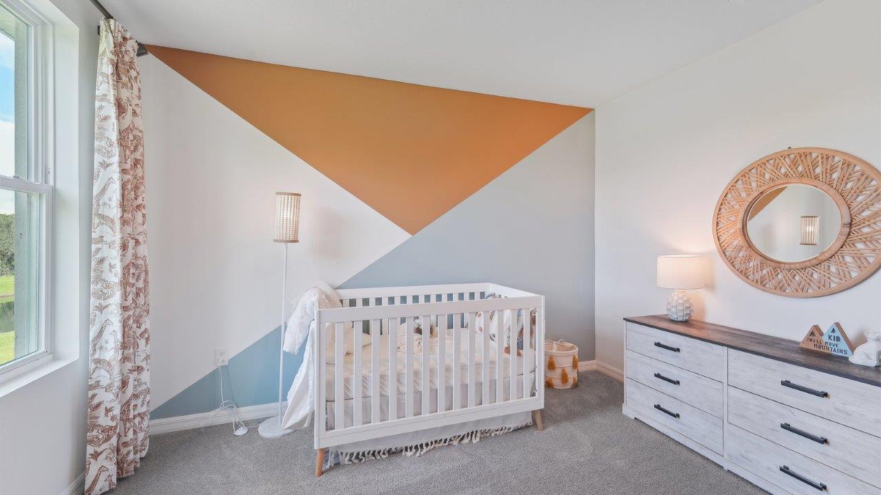 Child's nursery with crib, closet, soft seating and storage.