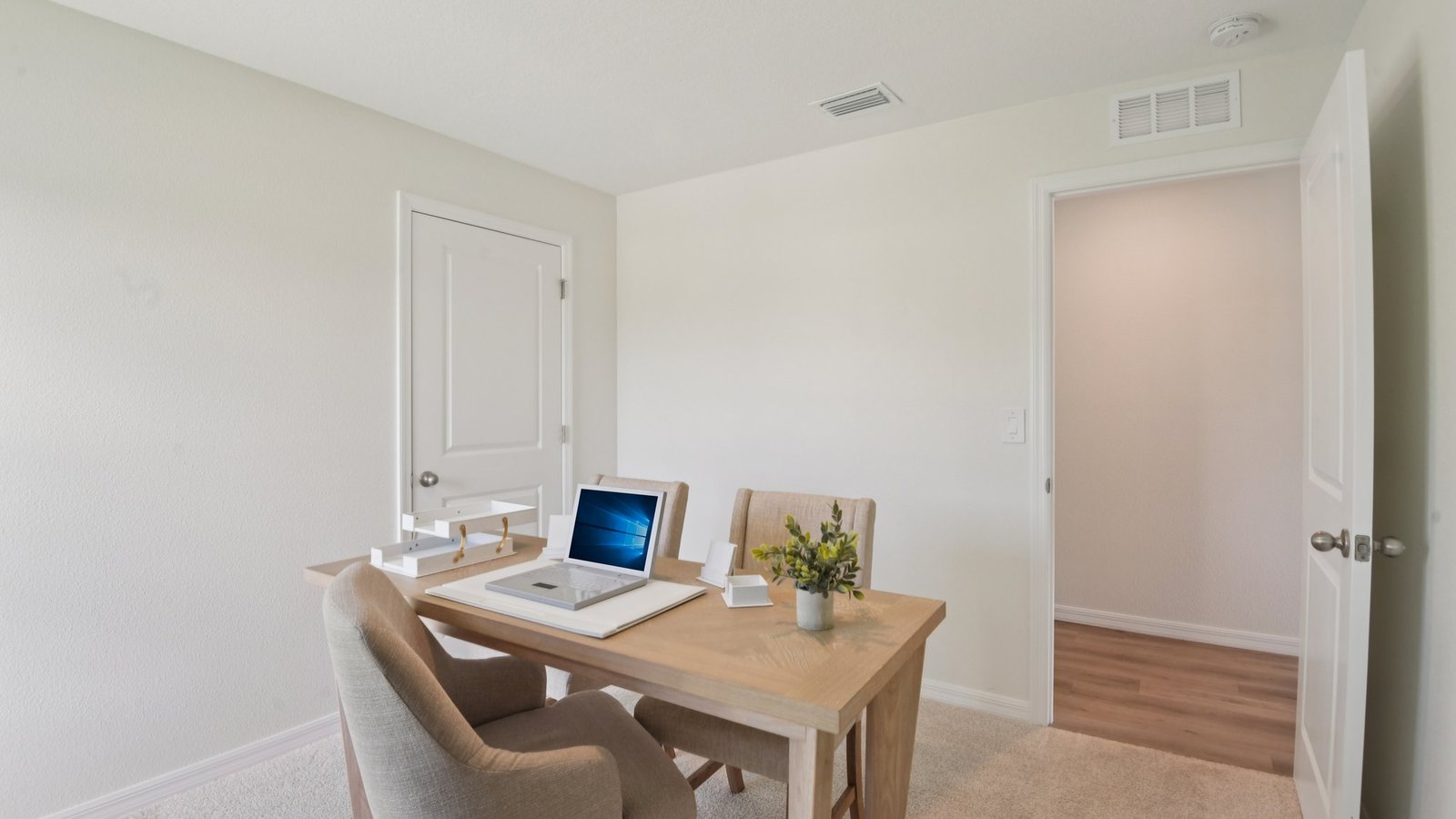 Functional home office with desk, chairs and space to work or play.