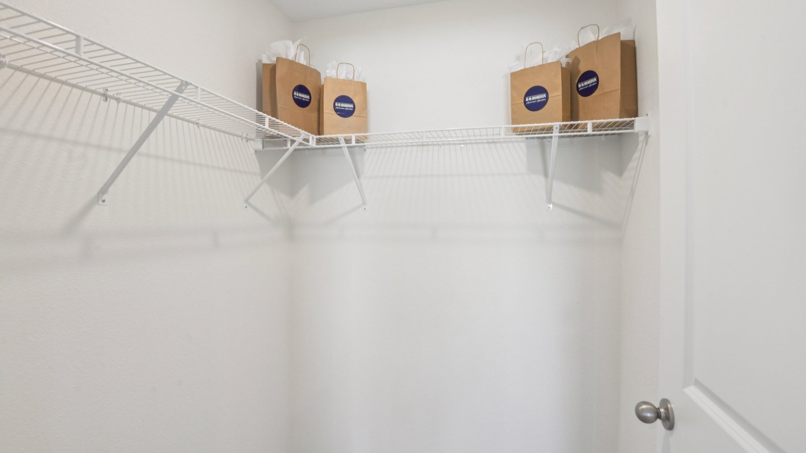 Spacious walk in closet with abundant shelving and storage.