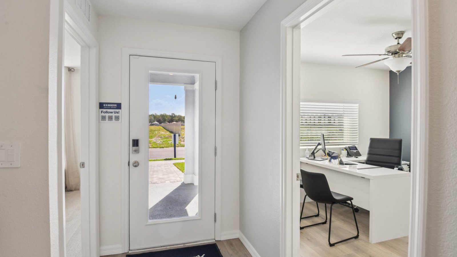 Home entry way thru the front door with LVP flooring and a view to the living space.