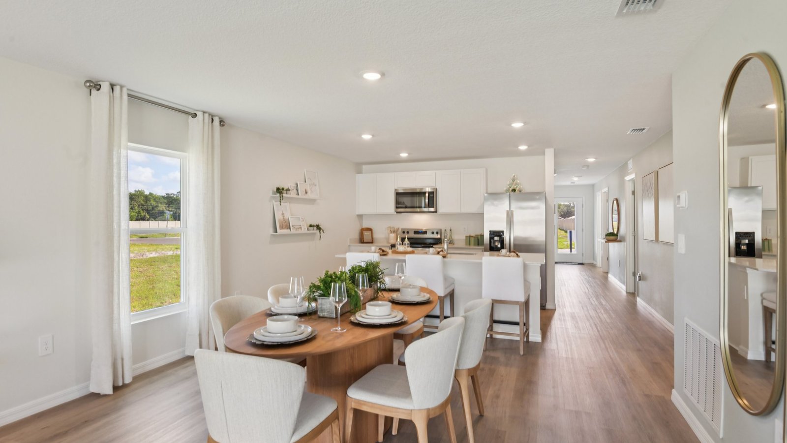 Dining room adjacent to the kitchen with table, chairs and LVP flooring.