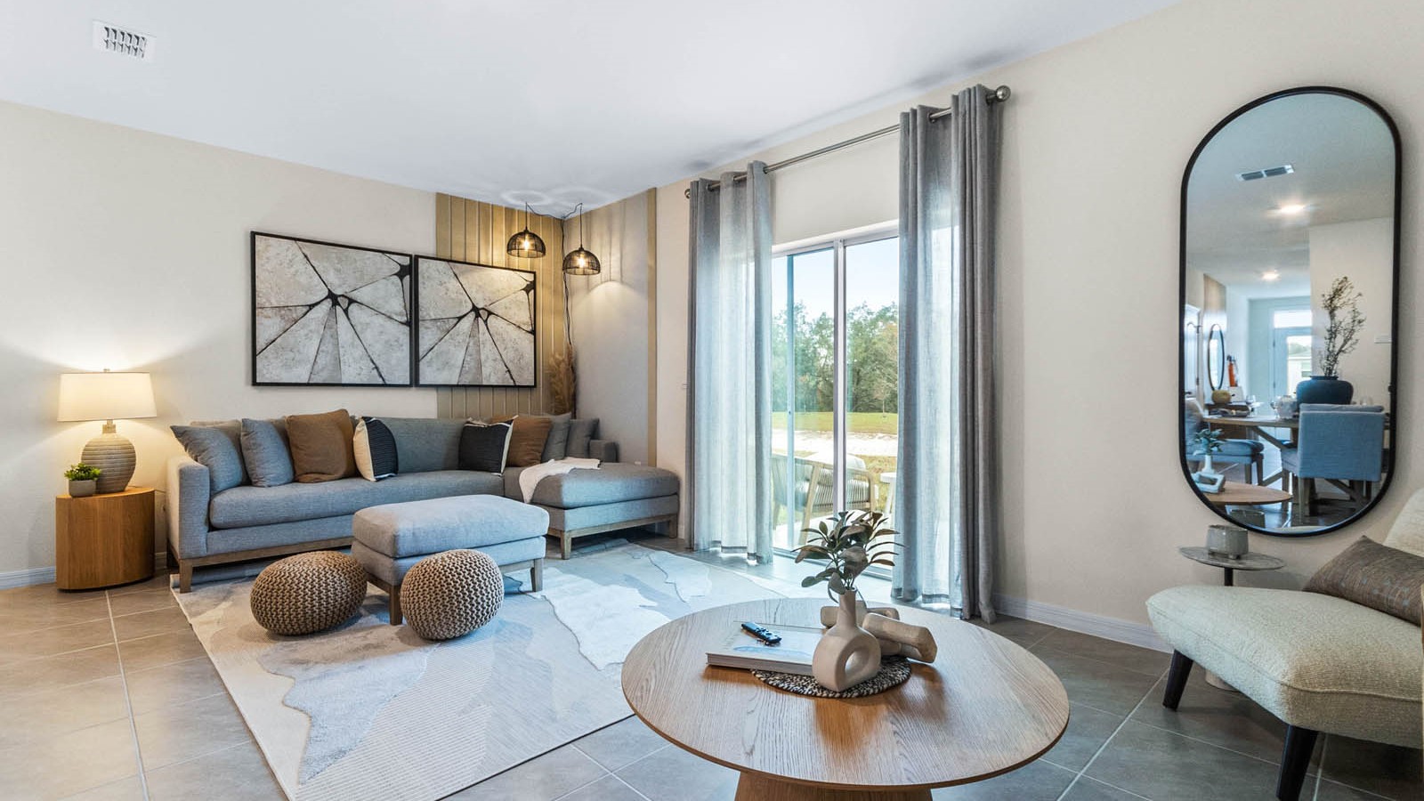 Open concept living area with couch seating and access to the backyard thru slider door.