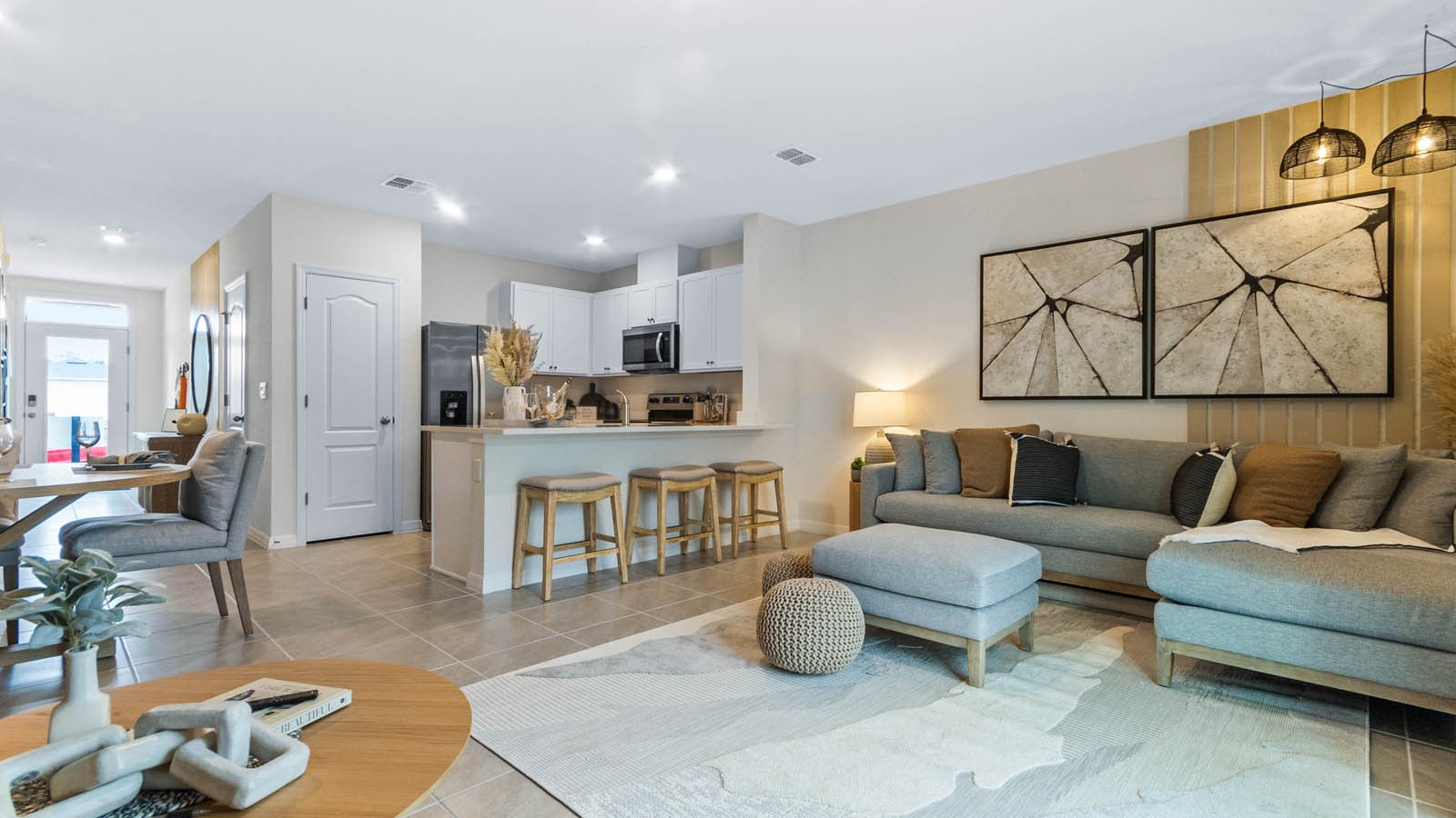 Open concept living area with couch seating and access to the backyard thru slider door.