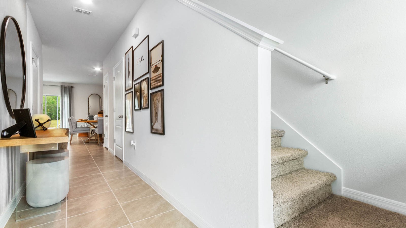Home entry way thru the front door with tile flooring and a view to the living space.