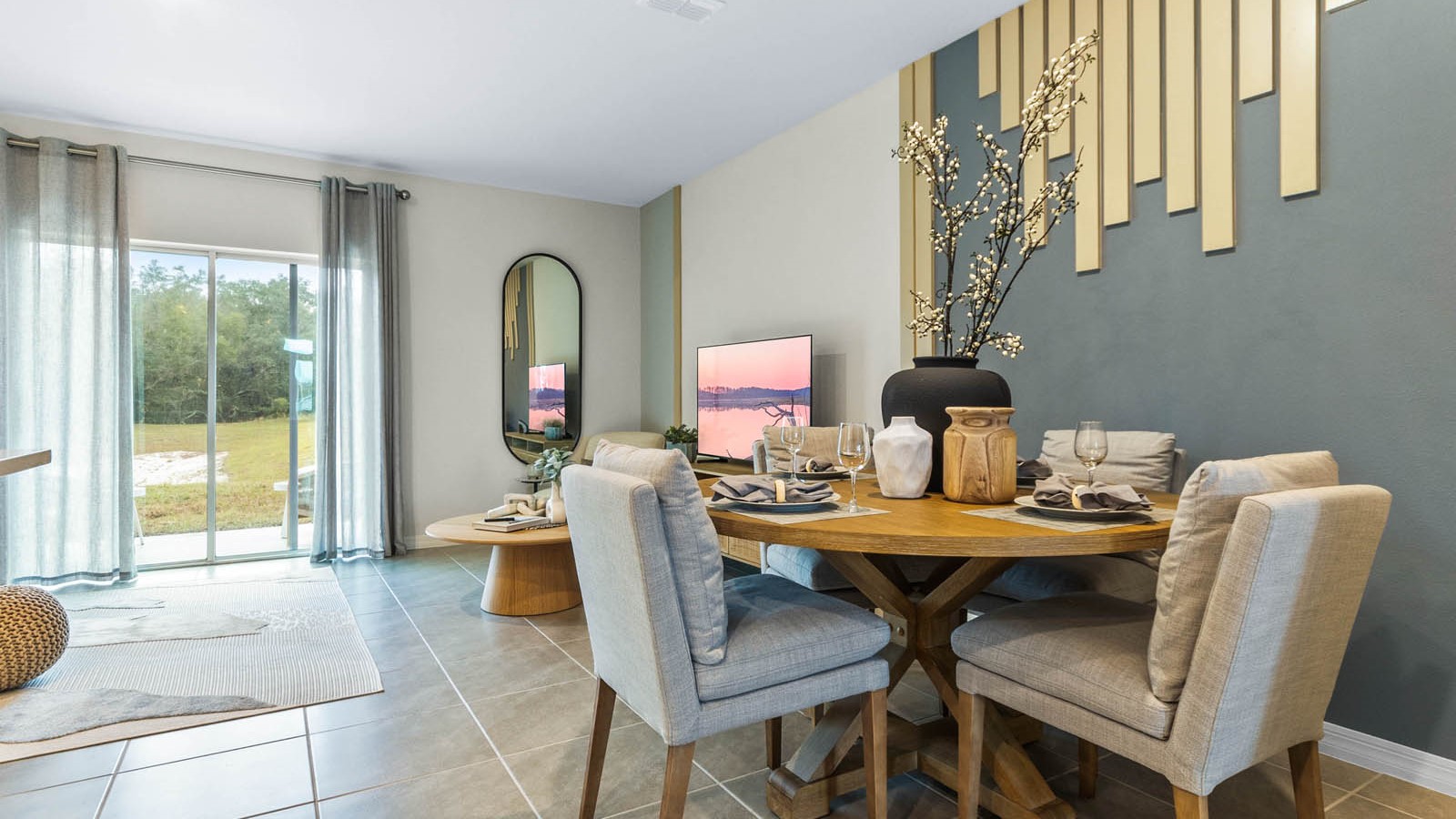 Dining room adjacent to the kitchen with table, chairs and tile flooring.