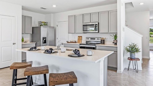 Central kitchen island with sink, seating, crafted to anchor the home, pantry, prep zones, perfect for entertaining and everyday gathering