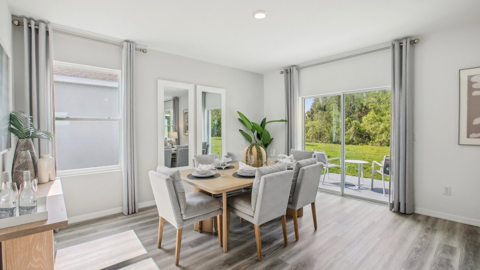 Dining room adjacent to the kitchen with table, chairs and tile flooring.