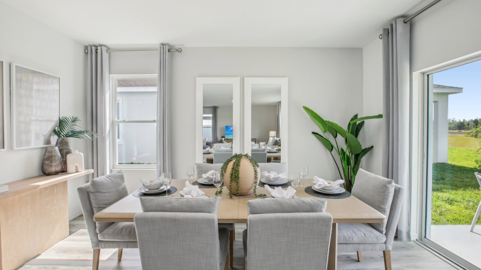 Dining room adjacent to the kitchen with table, chairs and tile flooring.