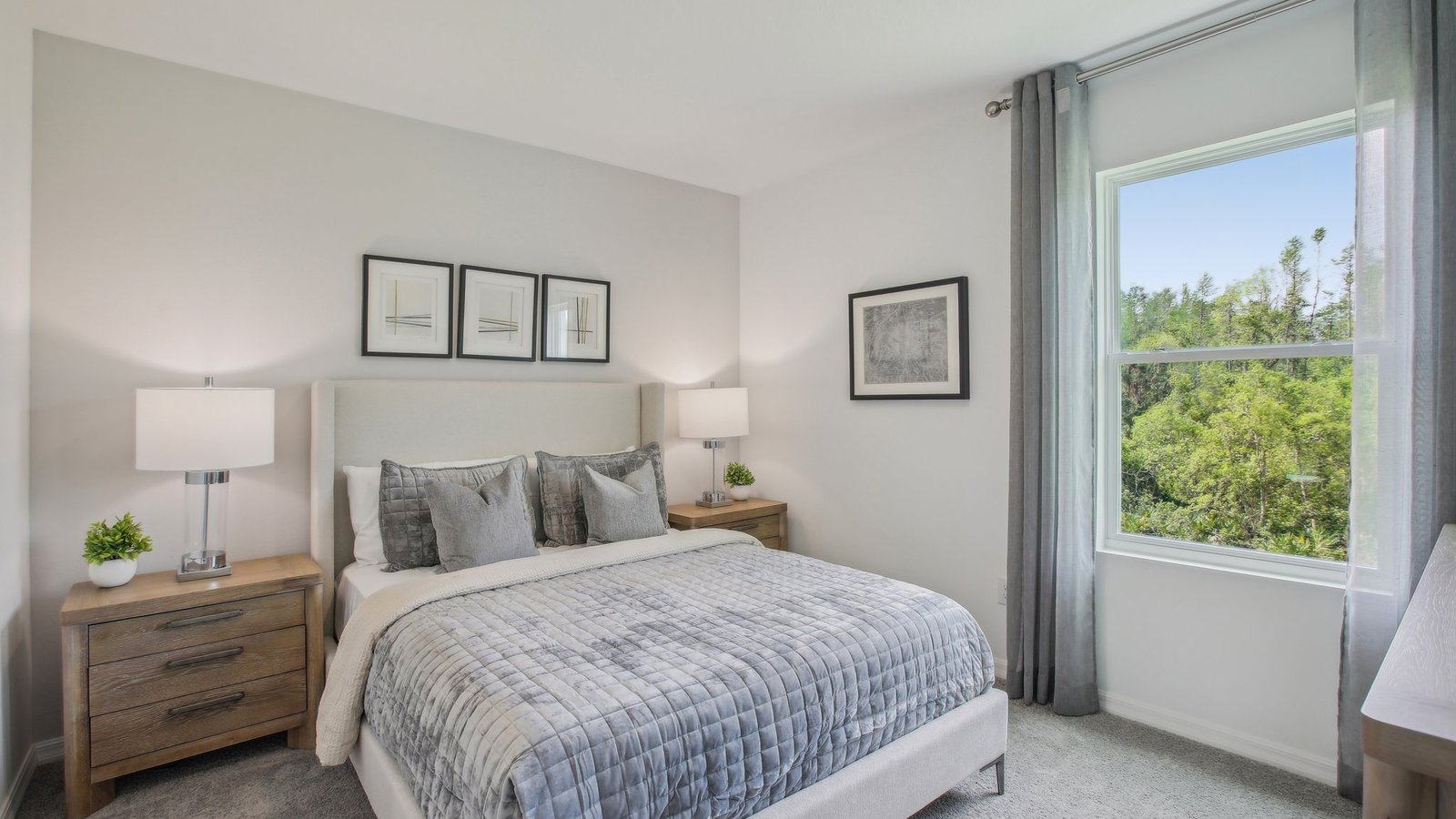 Guest bedroom with bed, nightstands, and a roomy closet for storage.