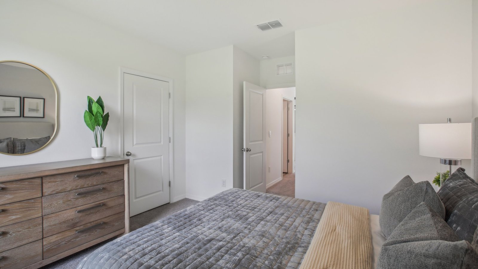 Guest bedroom with bed, nightstands, and a roomy closet for storage.