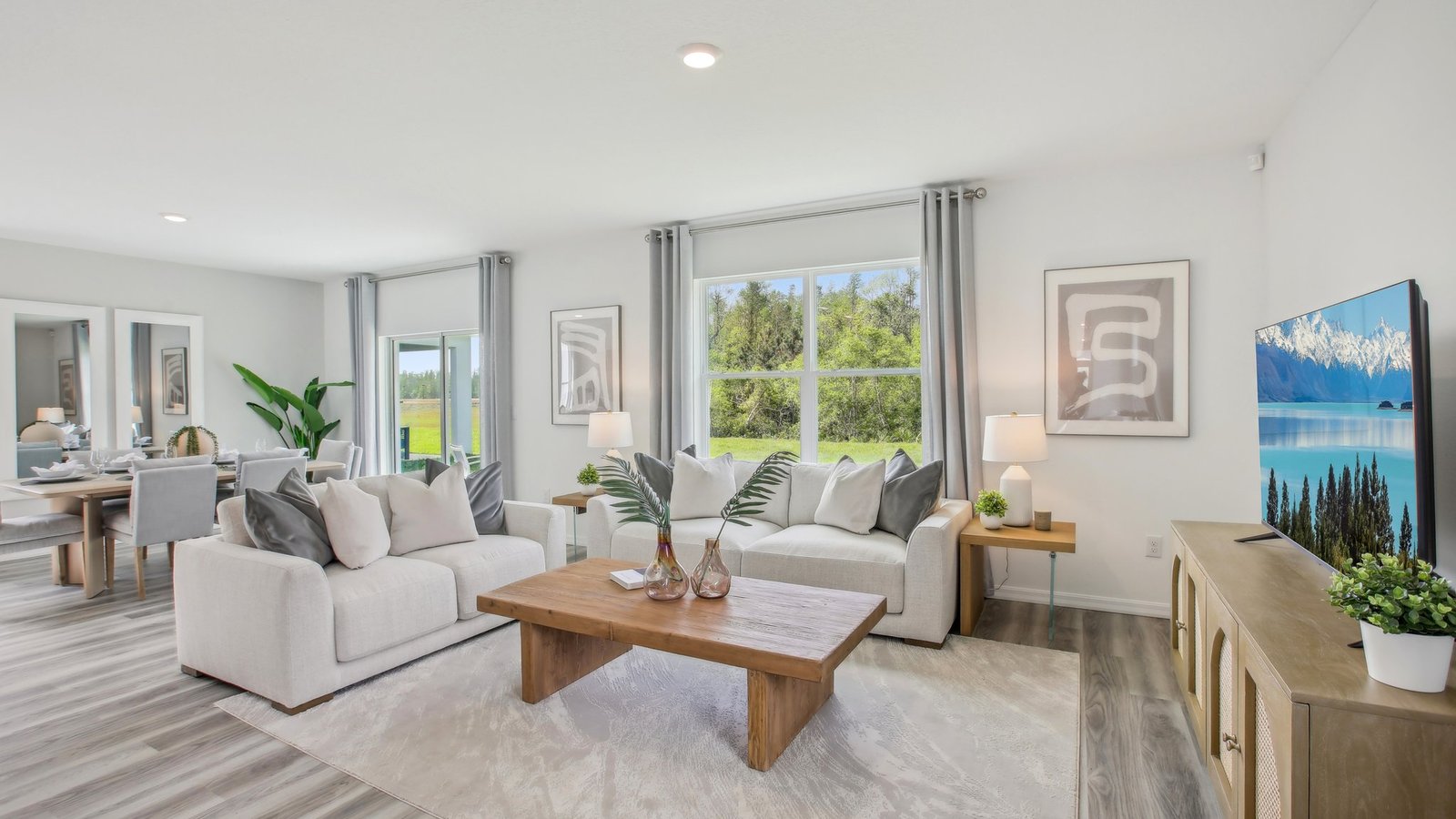 Open concept living area with couch seating and access to the backyard thru slider door.