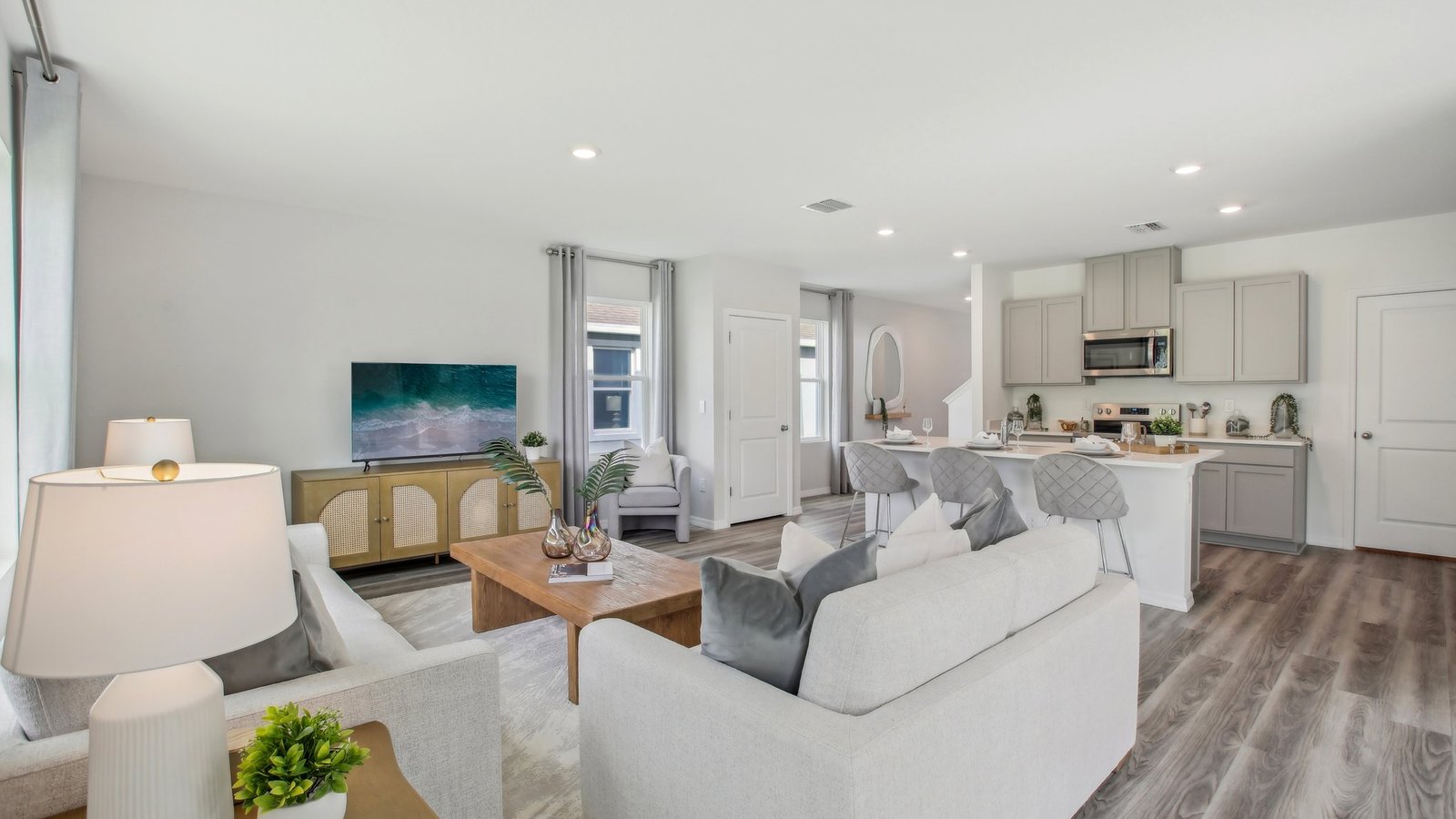 Open concept living area with couch seating and access to the backyard thru slider door.