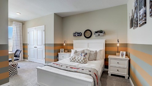 Guest bedroom with bed, nightstands and a roomy closet for storage.