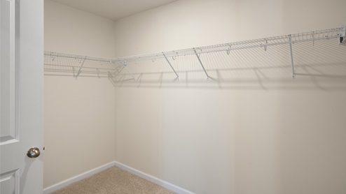 large walk in closet with built in wire shelving