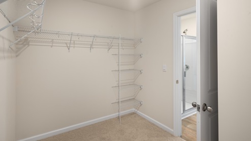 large walk in closet with built in wire shelving