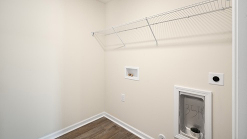 laundry room with washer and dryer hookups and built in wire shelving