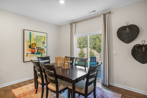 open concept dining space with sliding glass door to patio