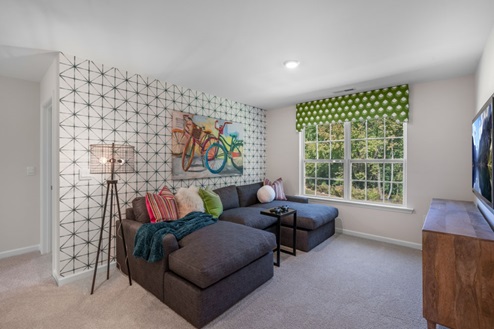 upstairs loft area with large windows and carpeting