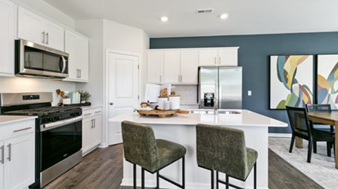 kitchen featuring white cabinetry, large island and stainless steel appliances