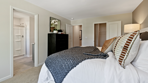 bedroom featuring a large bed, with a large window to the right of it