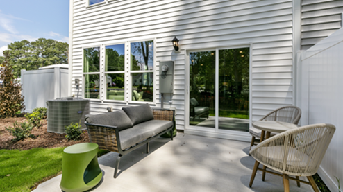 rear exterior of home featuring a concrete patio and privacy fence