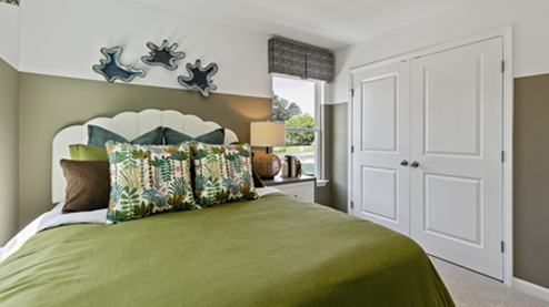 bedroom featuring olive green decor and 2 large windows