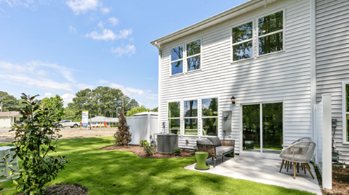 rear exterior of home featuring a concrete patio and privacy fence
