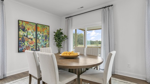 open concept dining space with sliding glass door to patio