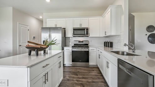Wilmington model kitchen area with stainless steel appliances