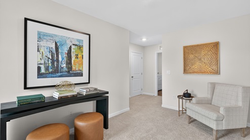 upstairs loft area with large windows and carpeting