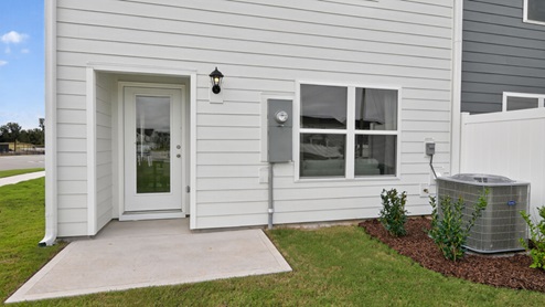 exterior patio with concrete slab and open yard