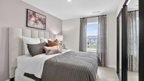 secondary bedroom with window and closet, carpeting