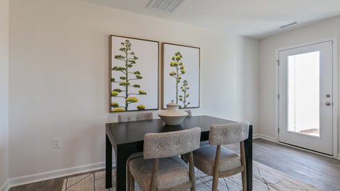 open concept dining space with glass door to patio