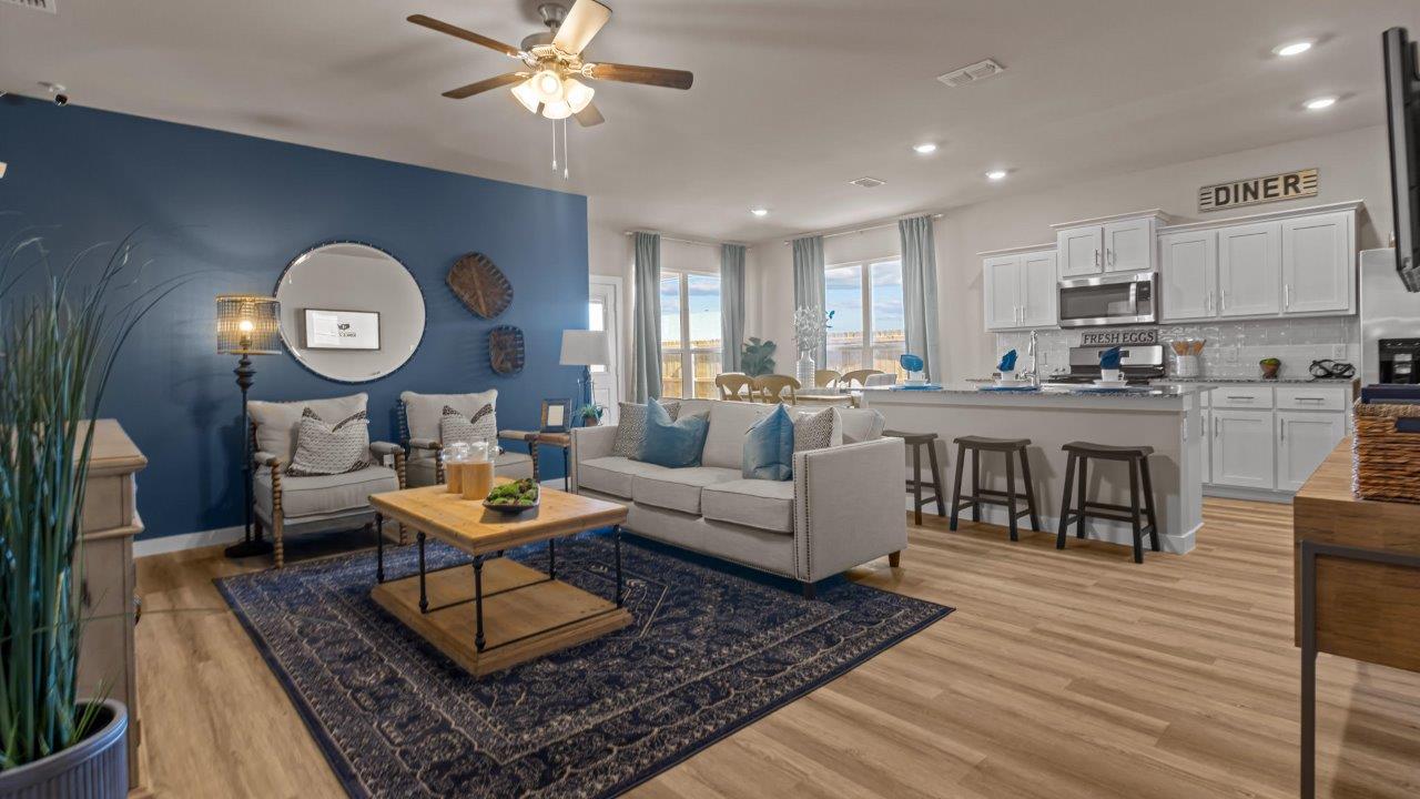 Spacious living and family room space with light allowing windows