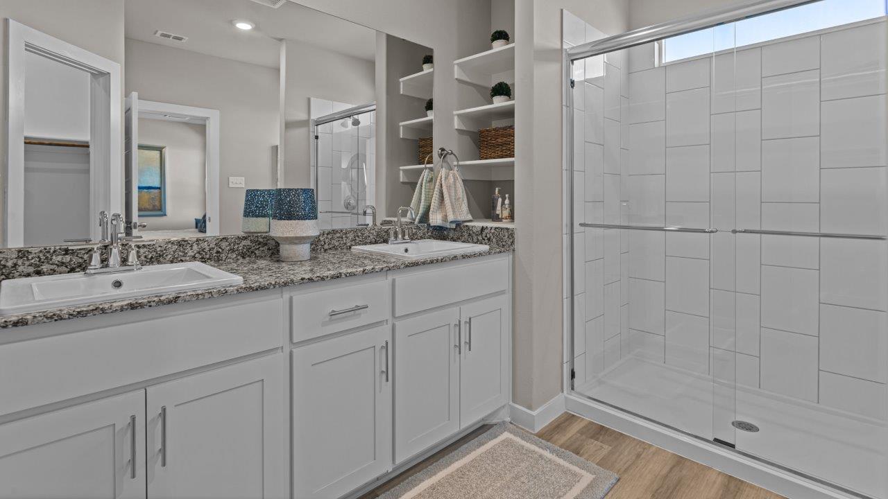 Primary bathroom with luxurious shower and built in vanity