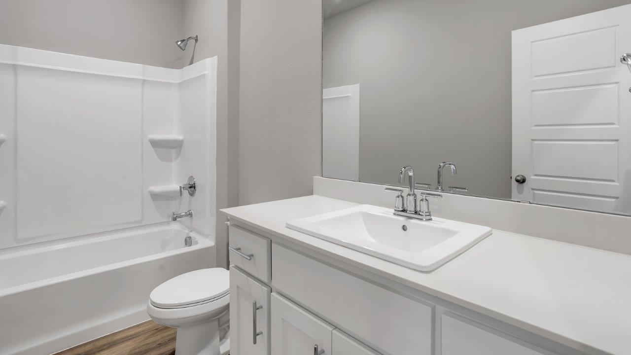 Guest bathroom with built in vanity and combination bathtub shower