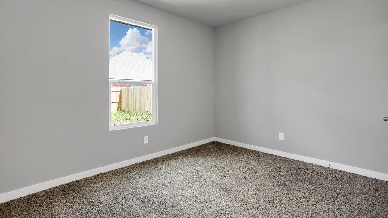 Front guest bedroom with ample natural light and plush carpet