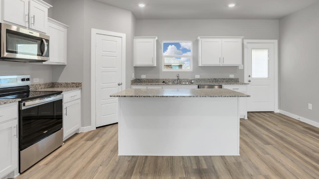 Spacious open concept kitchen with island and counter prep space