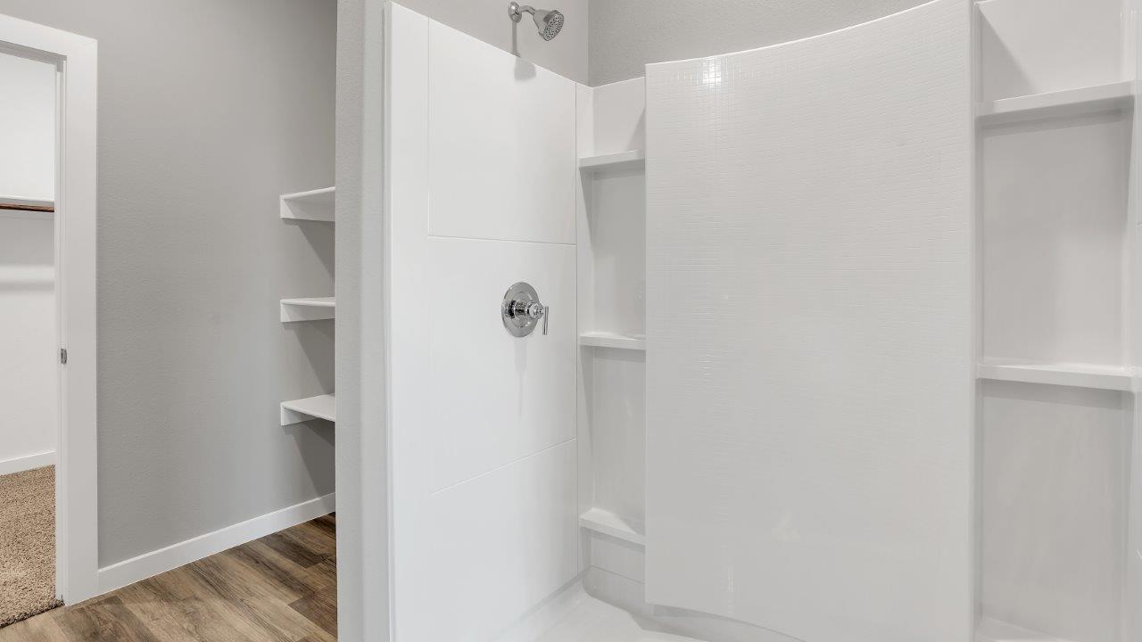 Primary bathroom with luxurious shower and built in storage